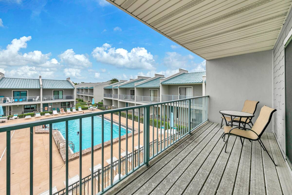Balcony with two chairs overlooking the shared pool